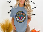 Light blue t-shirt with "Rejoice in Hope" emblem featuring a cross and shield.