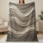 Textured brown and cream blanket with wavy lines and embellishments.