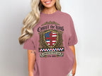 Pink t-shirt with Christ the King crest and "Sovereign over USA 1776-2026".
