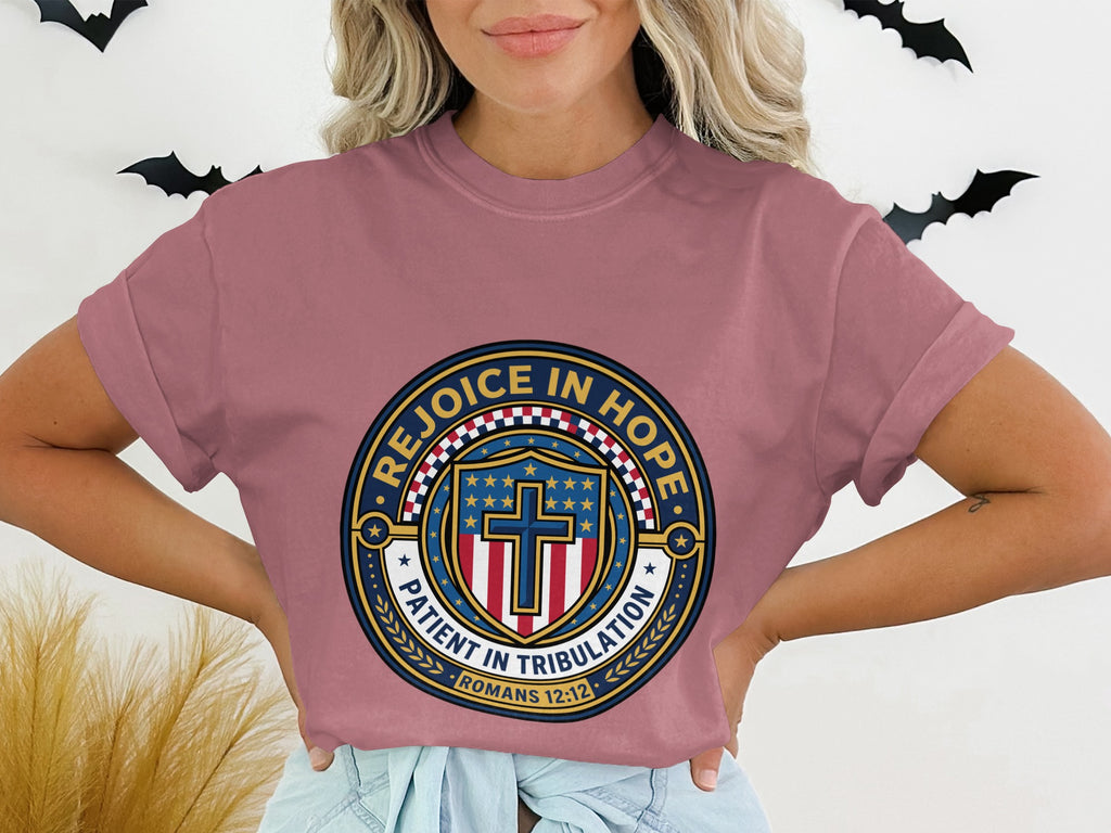 T-shirt with a circular graphic featuring a cross, stars, and "Rejoice in Hope Patient in Tribulation Romans 12:12".