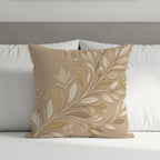 Beige throw pillow with embossed floral design on a bed.
