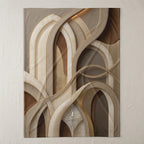 Abstract beige and brown woven blanket with decorative gold trim.