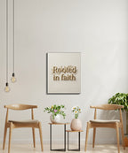 Wall art with "Rooted in faith" text, between two chairs and two small tables.
