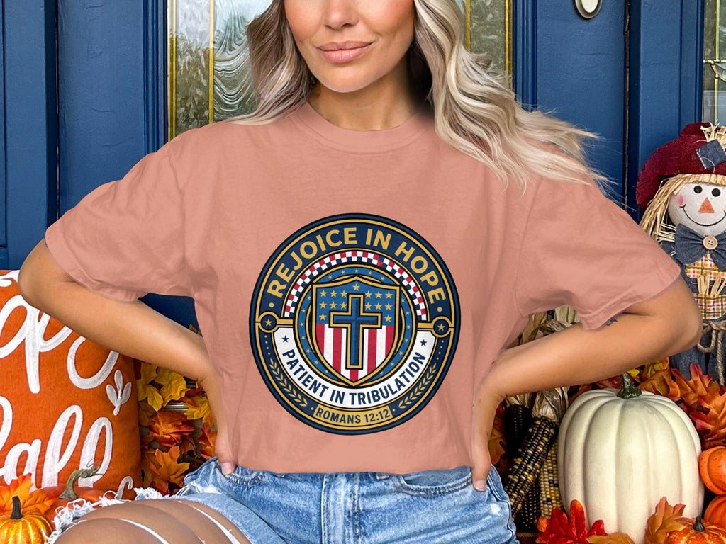 Salmon t-shirt with circular "Rejoice in Hope Patient in Tribulation Romans 12:12" graphic.