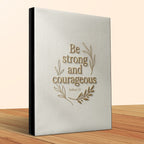 Be strong and courageous Bible with wooden desk background.
