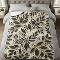 Bed with blanket featuring a black and gold floral leaf pattern with a dove.
