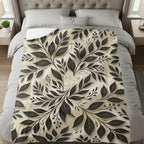 Bed with blanket featuring a black and gold floral leaf pattern with a dove.