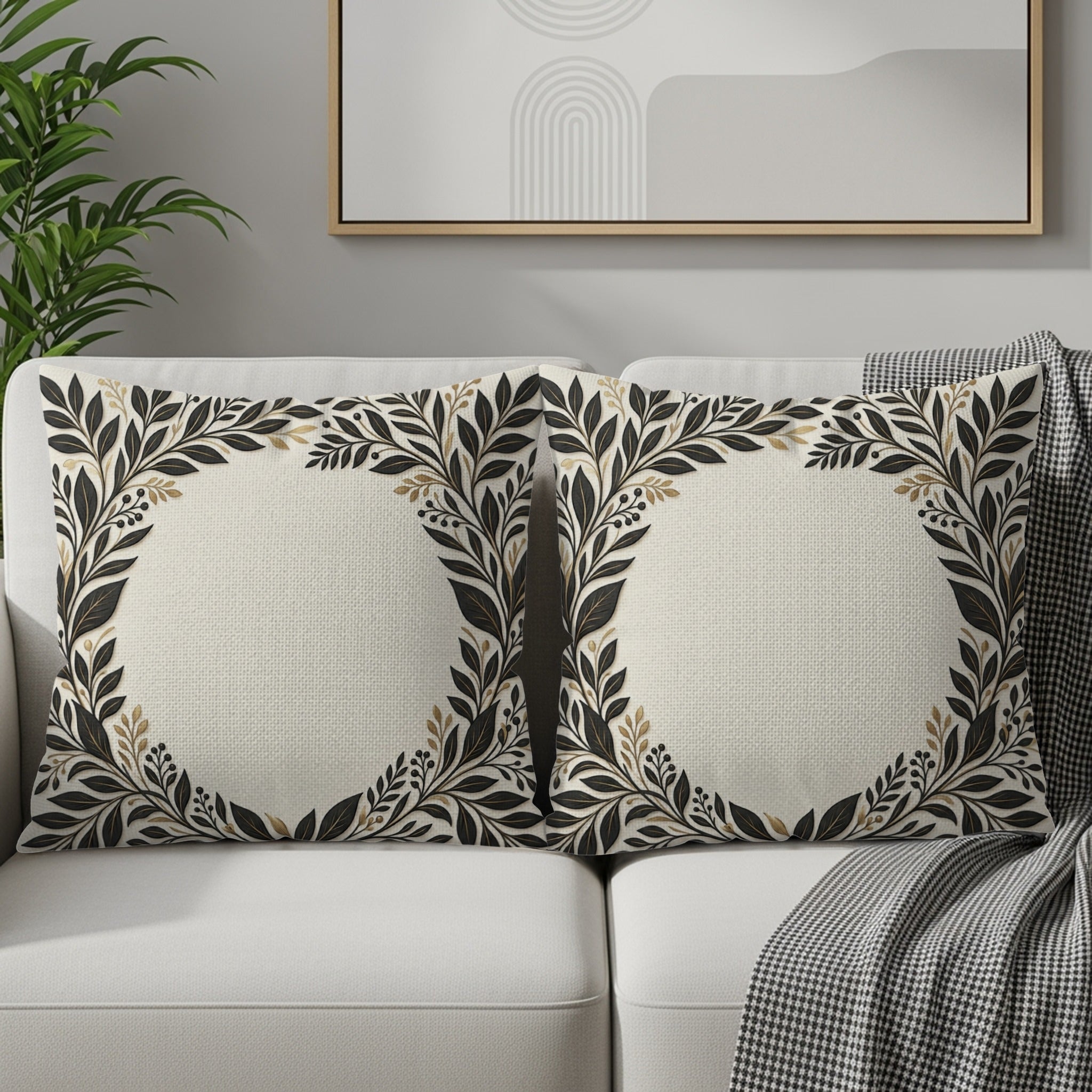 Two square throw pillows with a floral wreath design on a couch.
